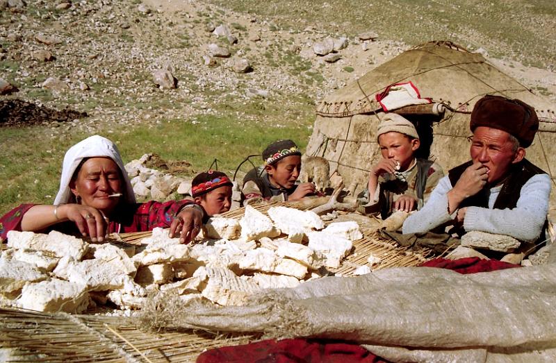 Kirghize_family_with_cheese_001.jpg - Family resting and eating Kurut, dry and very hard cheese