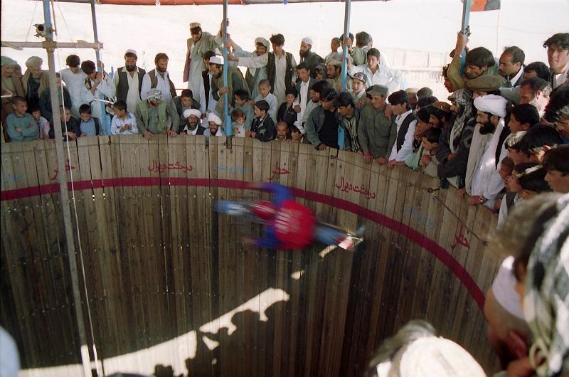 Acrobatic_moto_show.jpg - Acrobatic moto show in a park, north of Herat. The moto driver is 10 meters above the ground.